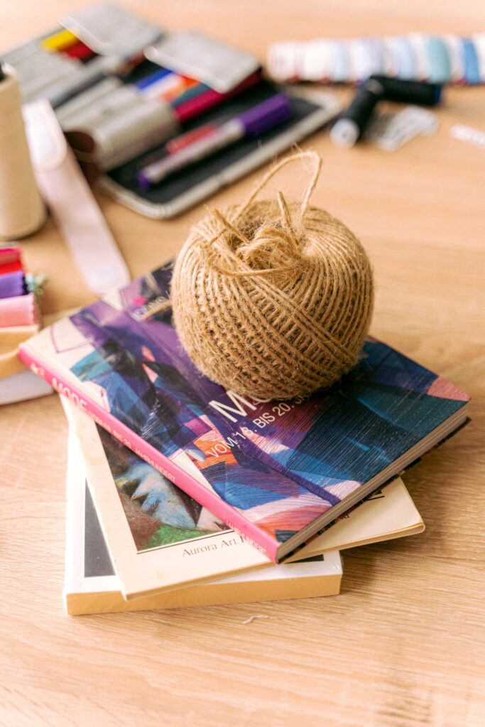 Books yarn and creative inspiration creating a message to stop doomscrolling gently.