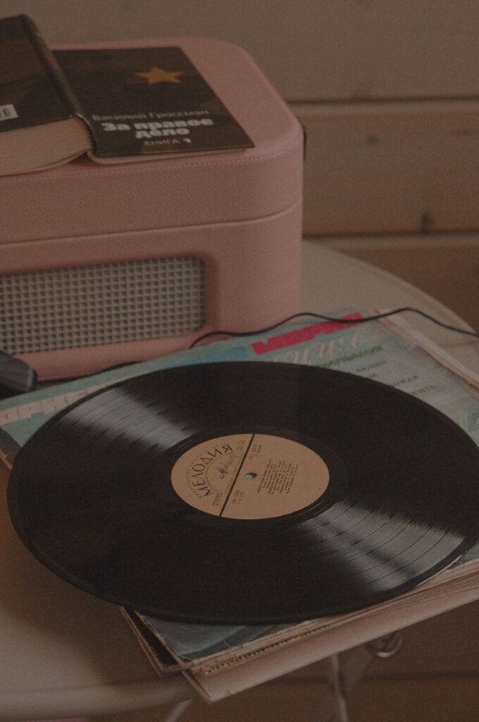 Vintage record player and vinyl collection arranged in a cozy home listening corner.