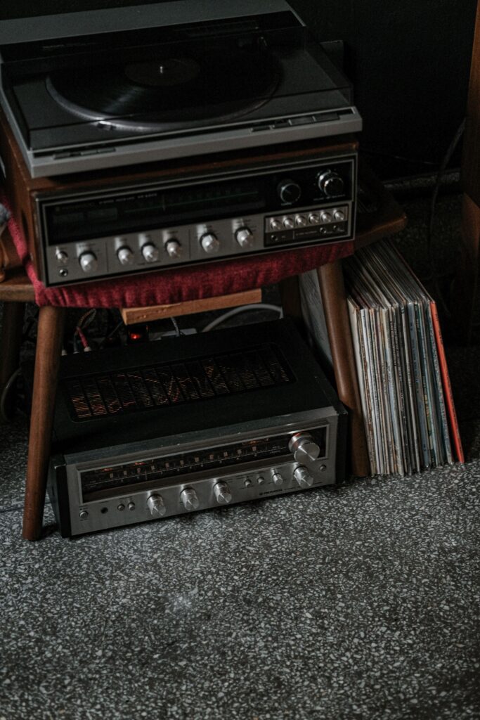 Vintage record player and vinyl collection arranged in a cozy home listening corner.