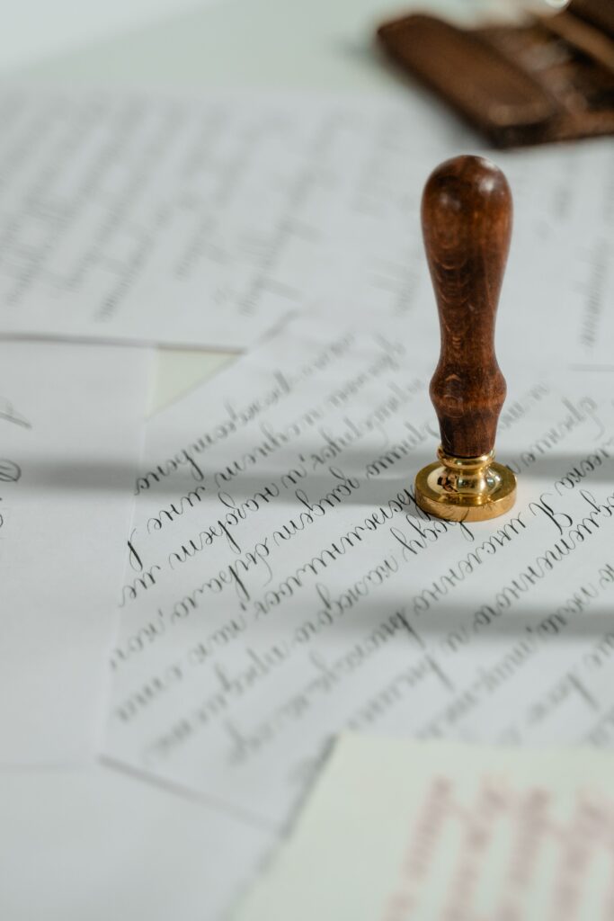 Vintage wax seal stamp resting on handwritten letters, capturing the charm of slow living, letter writing, and analog hobbies.