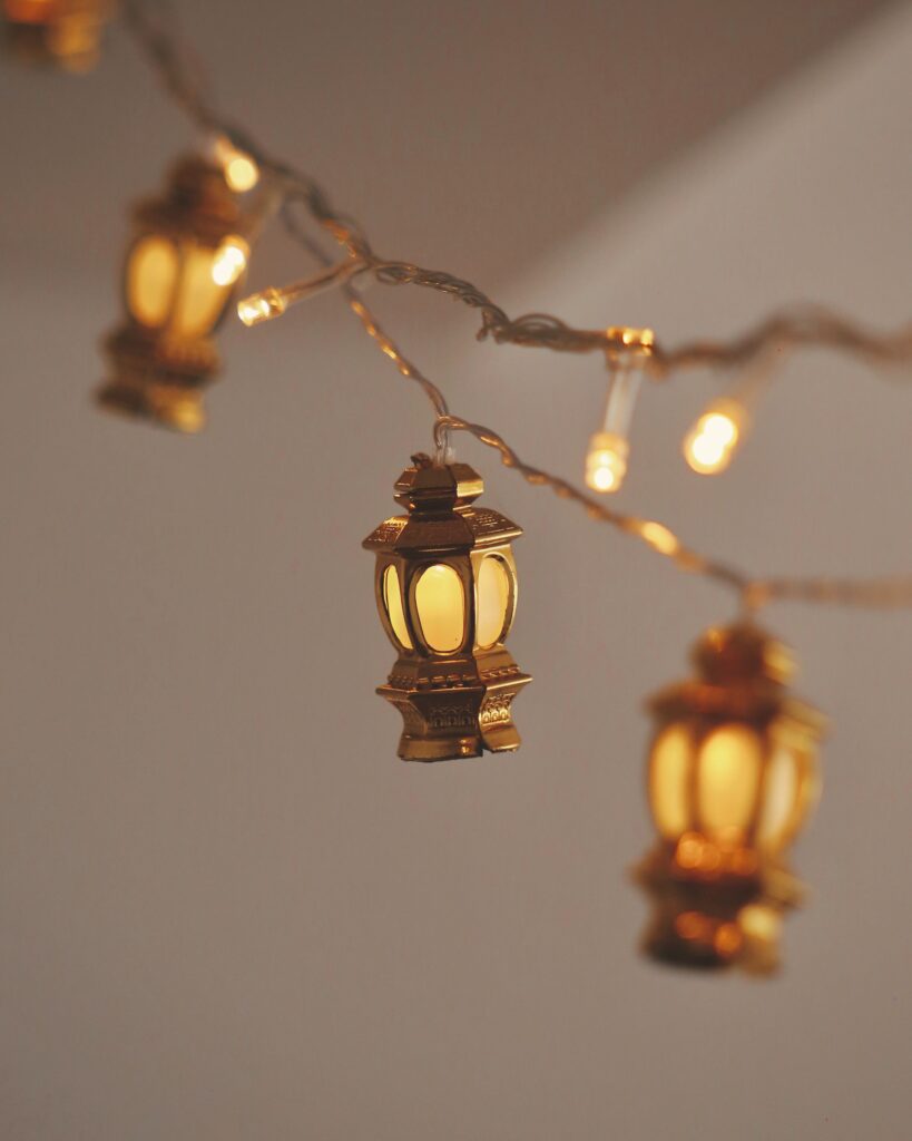 Warm toned string lights with decorative lanterns glowing softly indoors