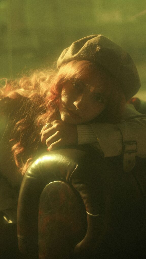 Dreamy portrait bathed in warm golden light creating a reflective nostalgic mood.