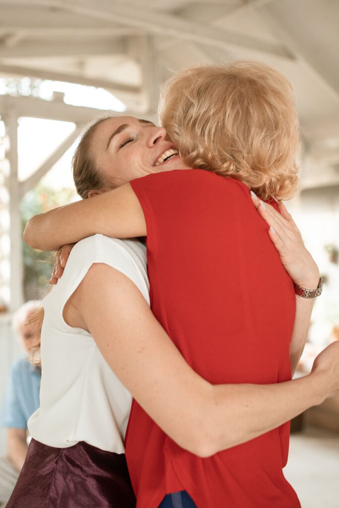 Two people embracing warmly, celebrating compassion, gratitude, and the quiet return of kindness.